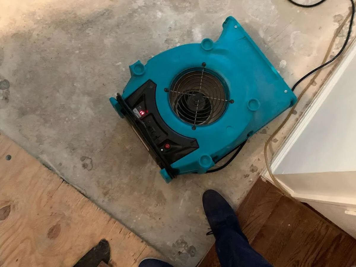 Air mover drying subfloor during Leak Detection & Repair in Barnesville